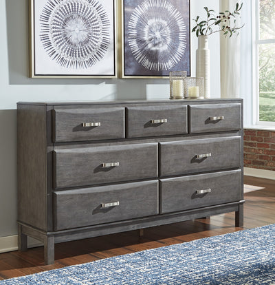 Caitbrook Gray Dresser in a bedroom