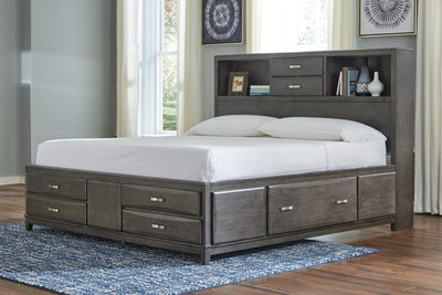 Caitbrook Gray King Storage Bed in a bedroom