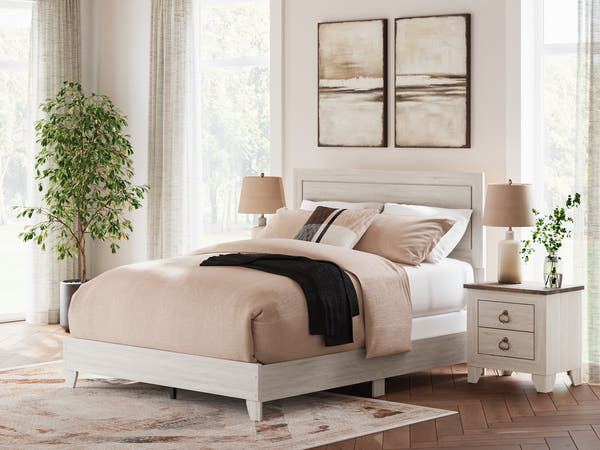 Laigmeyer Whitewash Panel Bed in a bedroom