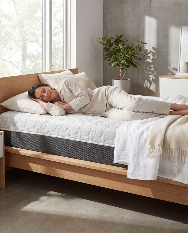 Person sleeping peacefully featuring Omne Copper Recovery hybrid mattress