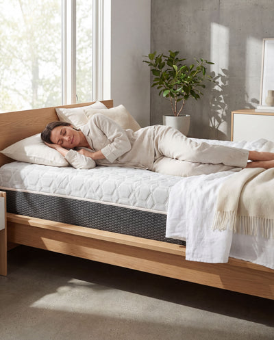 Person sleeping peacefully featuring Omne Copper Recovery hybrid mattress
