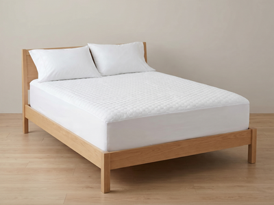 Chill Shield protector fitted on a bed — hex top, white sides