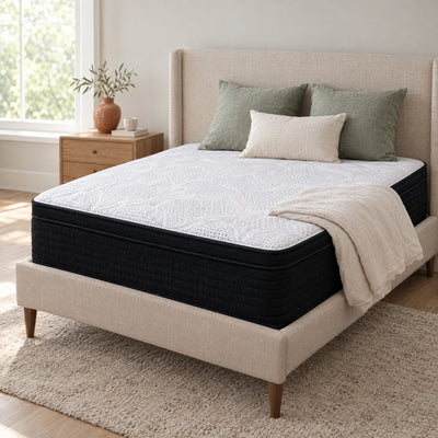 Classic Hybrid 13 inch mattress with white knit top on an upholstered bed