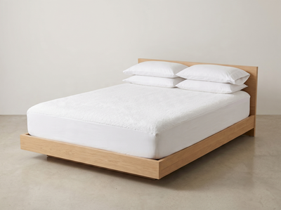 Terry mattress protector fitted on a bed